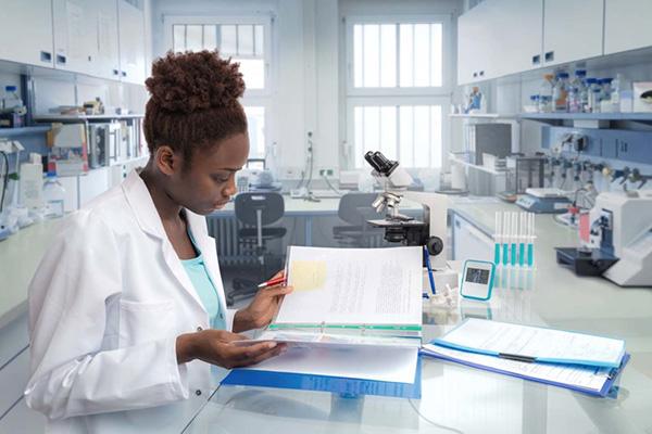 scientist reviewing data on a table in the middle of a lab